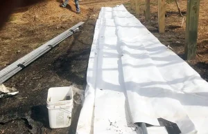 fabric building cover rolled out - ready to pull